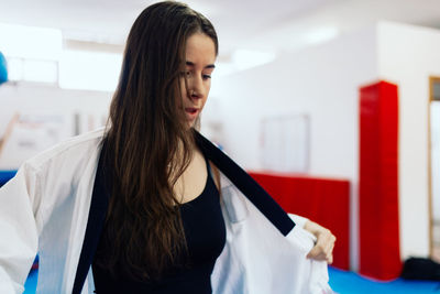 Young woman wearing uniform at gym