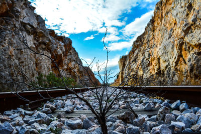 Footbridge over mountain against sky