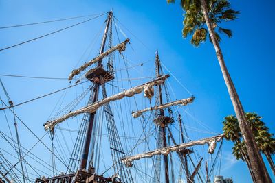 Low angle view of power lines against clear blue sky