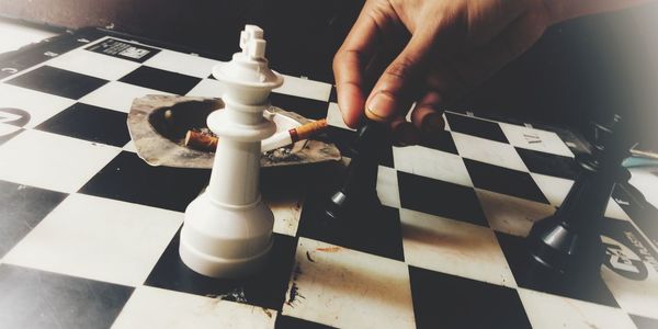 Low angle view of man playing on chess board