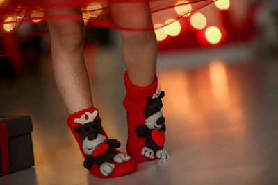 Kid's feet dressed in red christmas socks.