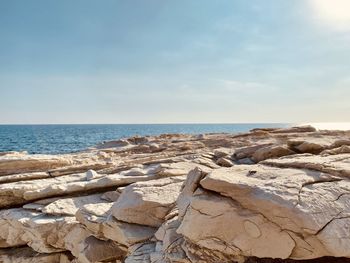 Selected focus white stone texture for product to display with sea in background against sky