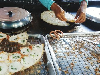 Cropped hand preparing food