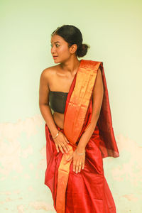 Young woman standing against white background