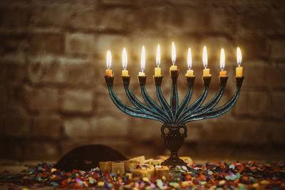 Close-up of illuminated candles on table