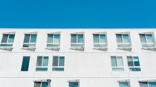 Low angle view of building against clear blue sky