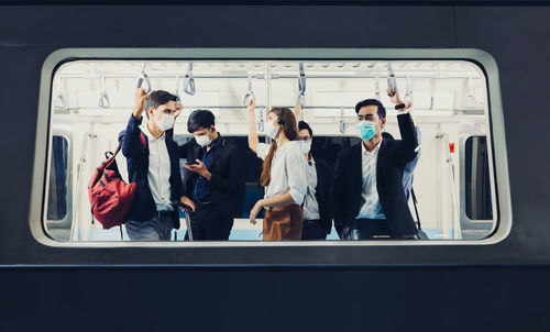 People on the train wear anti-virus masks and travel during rush hours. passengers inside the train