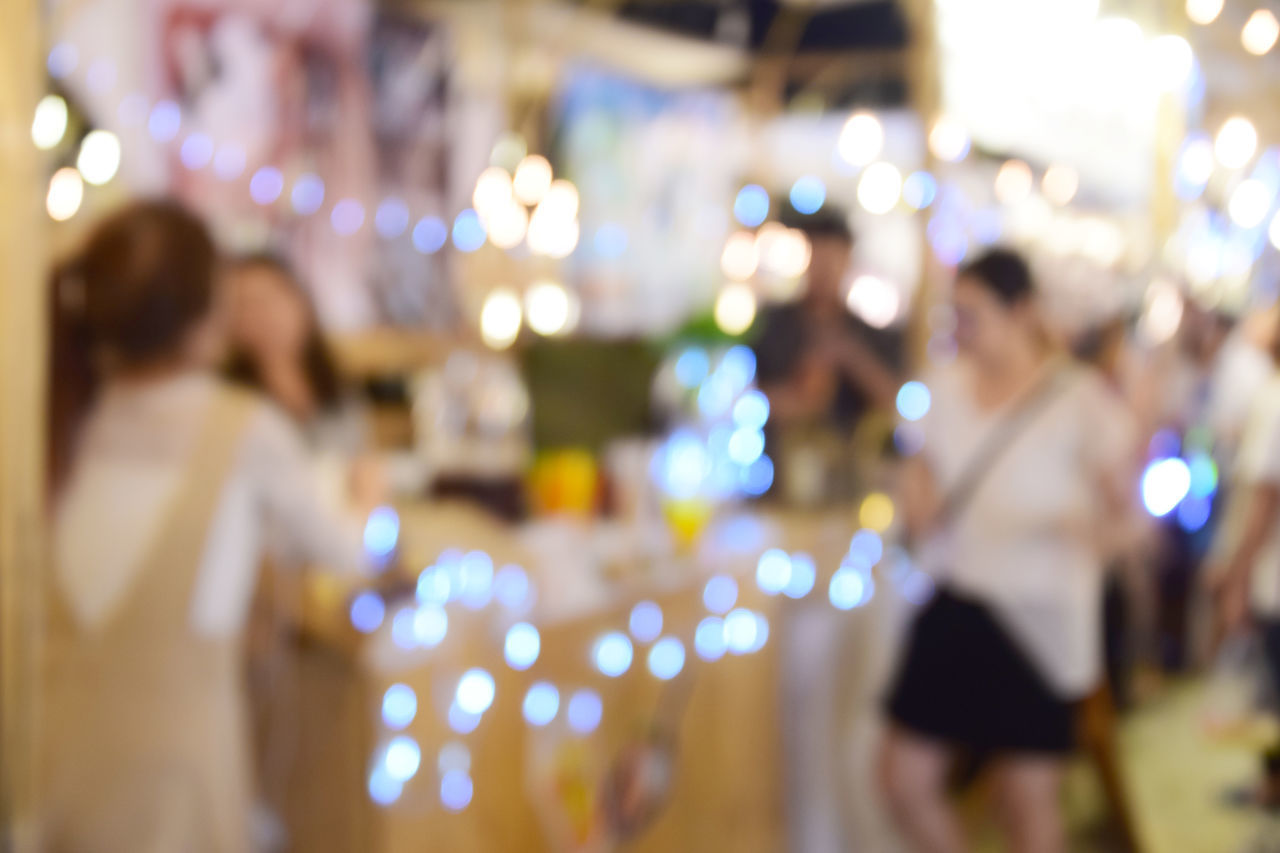 REAR VIEW OF PEOPLE IN ILLUMINATED LIGHTS