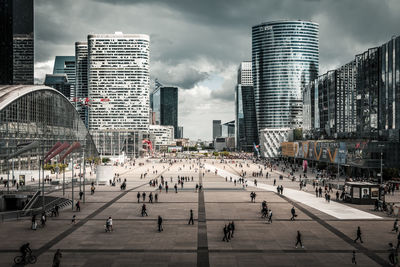 High angle view of people on street amidst buildings in city