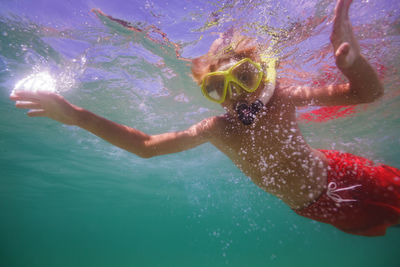 Young man swimming in sea