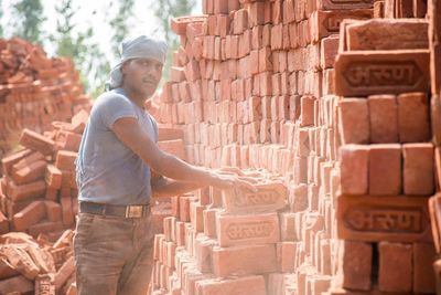 Man working on stack of firewood