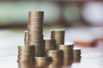 Close-up of coin stack on table