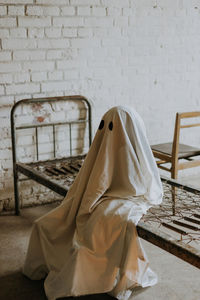 White chair on table against wall