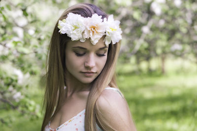 Portrait of beautiful woman with red flower