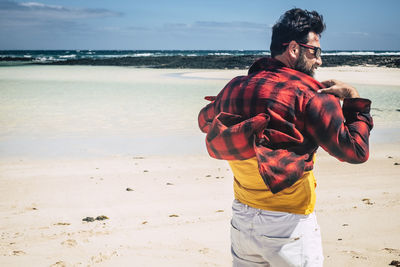 Man standing on beach against sea