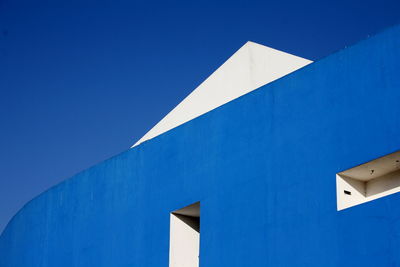 Low angle view of building against clear blue sky