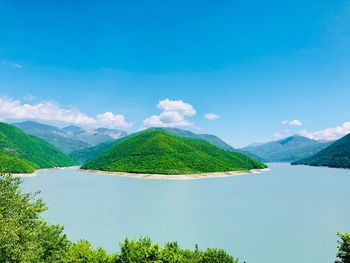 Scenic view of mountains against blue sky