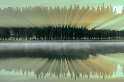 Reflection of trees in lake against sky