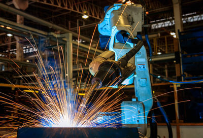 Low angle view of robot welding at factory