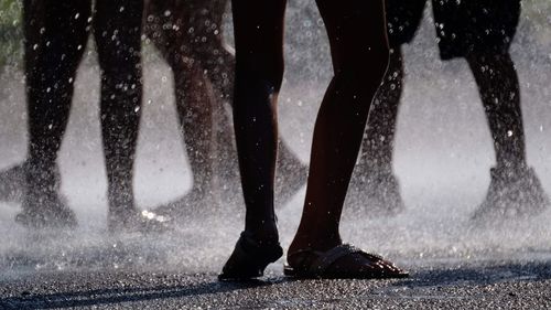 Low section of people standing on street during rainy season