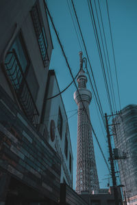 Low angle view of communications tower against sky