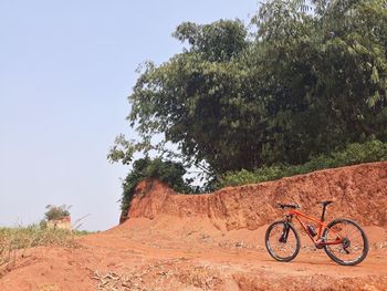 Bicycle on road against clear sky