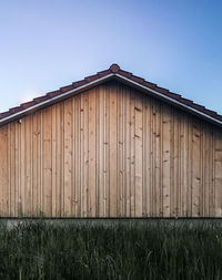 Barn on field against clear sky