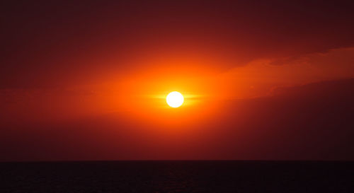 Scenic view of sea against orange sky