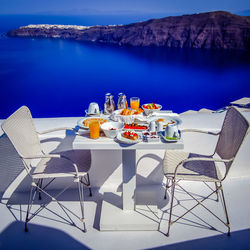 Chairs and table against calm blue sea