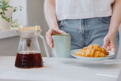 Midsection of woman with food and tea