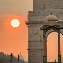 Triumphal arch against sky during sunset