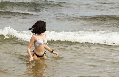 Rear view of man in sea