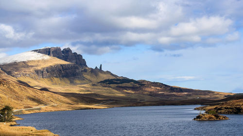 Scenic view of sea and mountains against sky