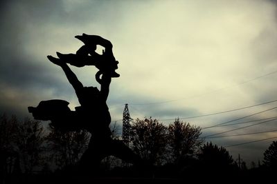 Low angle view of power lines against sky