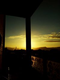 Silhouette cityscape against sky during sunset