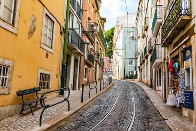 The 28e tram passes through a narrow street in lisboa old town, lisbon, portugal