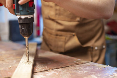 Midsection of man working in workshop