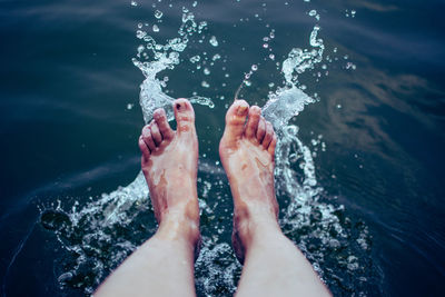 Low section of man feet in swimming pool