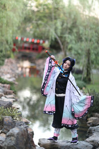 Low angle view of woman standing on rock