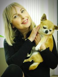 Portrait of young woman with dog