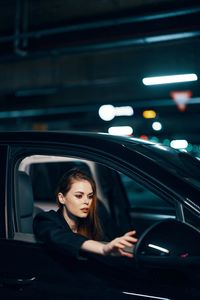 Young woman sitting in car