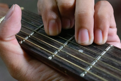 Midsection of person playing guitar