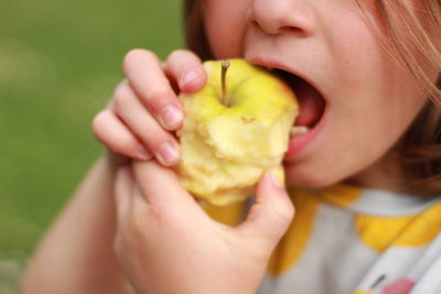 Close-up of woman eating apple