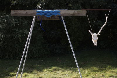 View of swing hanging on field