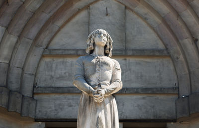 Low angle view of statue against building