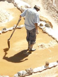 Low section of man working at shore