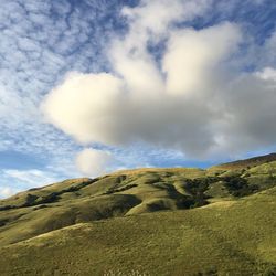 Scenic view of mountains against cloudy sky