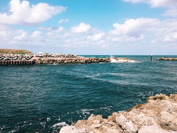 Scenic view of sea against cloudy sky