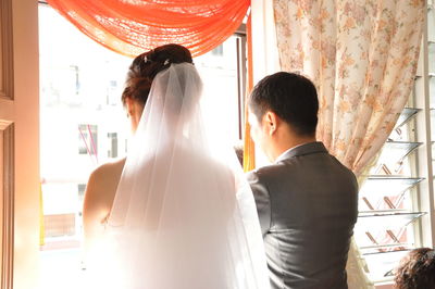 Rear view of couple standing in corridor