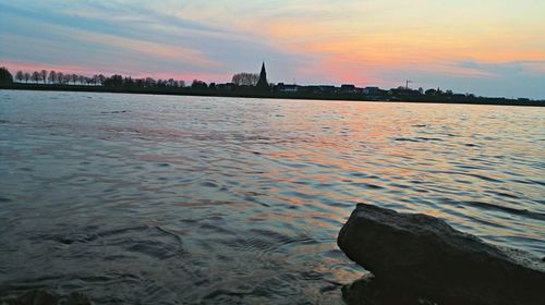 Scenic view of river at sunset